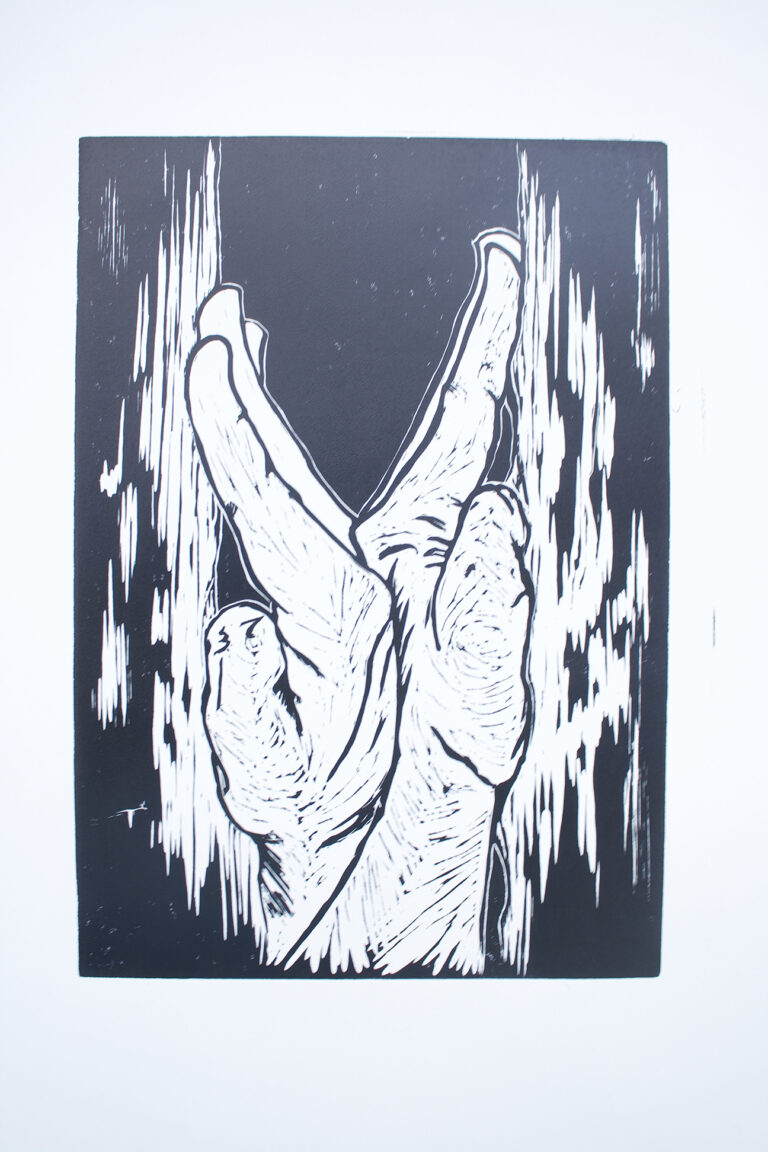 linoprint in black of two hands